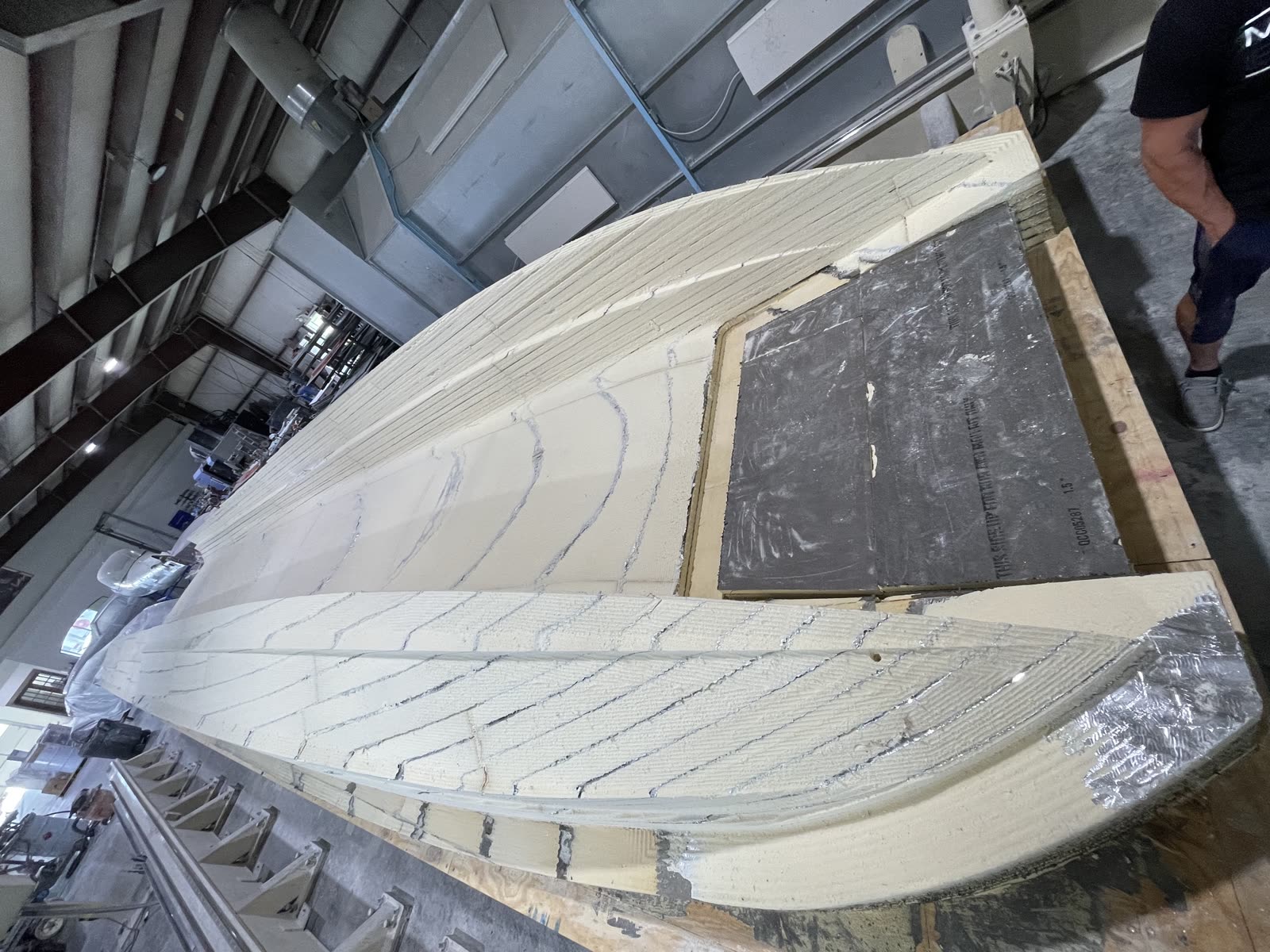 Five-axis CNC router carving the Platinum 428 hull plug