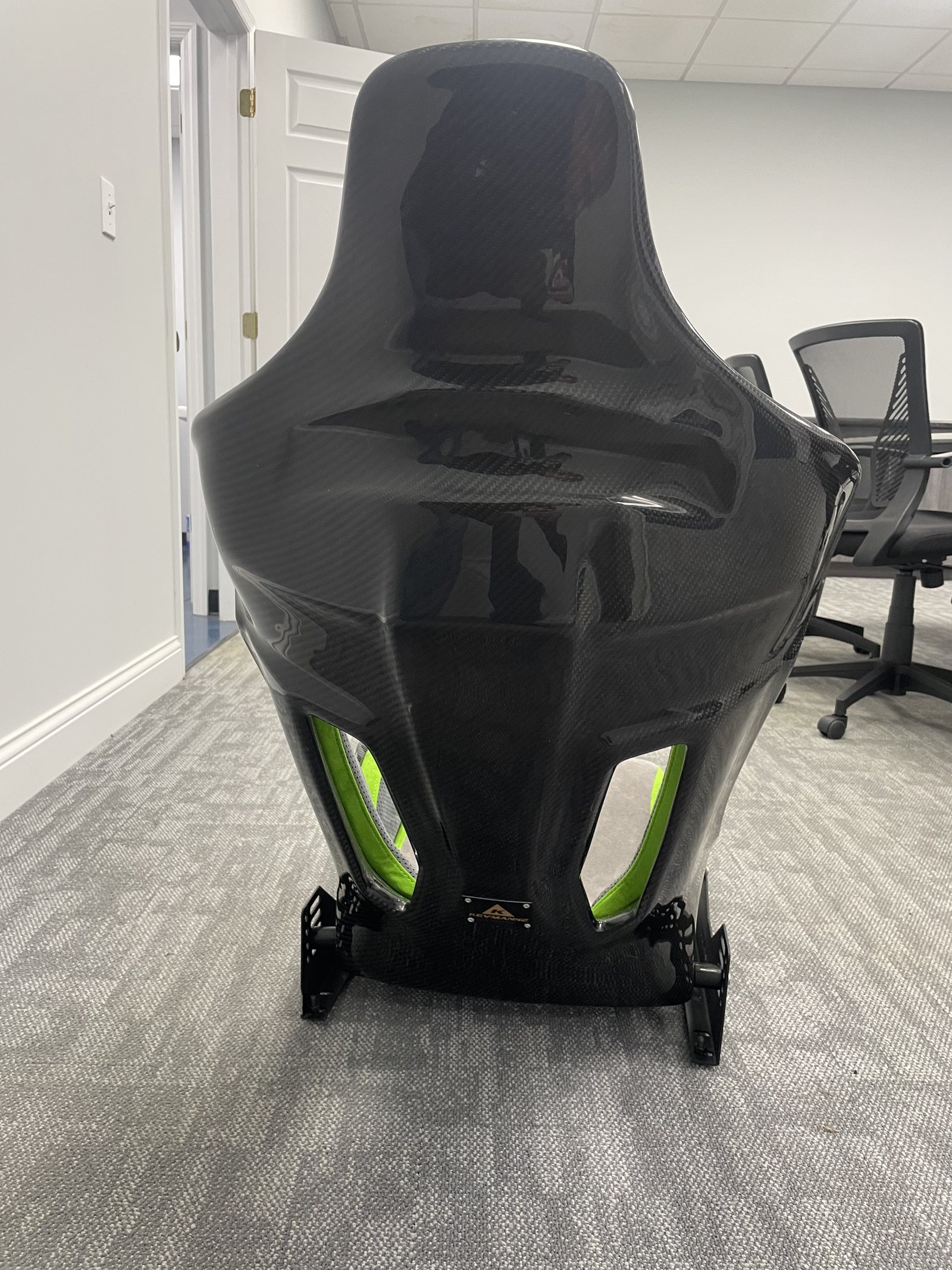 In-house carbon fiber seat shell with lime accent